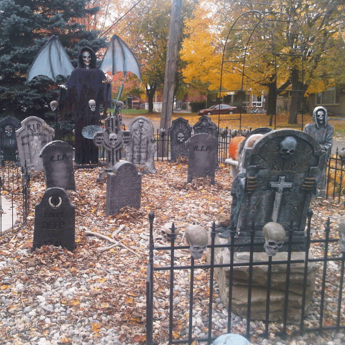 Scary ways to decorate your house for Halloween with a front yard graveyard display