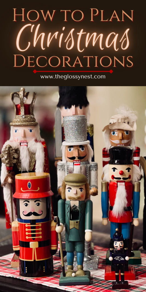 A festive display of nutcracker figures, each uniquely dressed in vibrant uniforms and hats. The text above reads "How to Plan Christmas Decorations" with a website link: www.theglossynest.com. The scene evokes a classic holiday atmosphere.