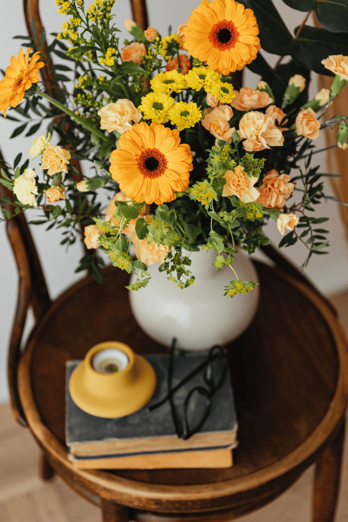 Spring flowers in a vase on a chair