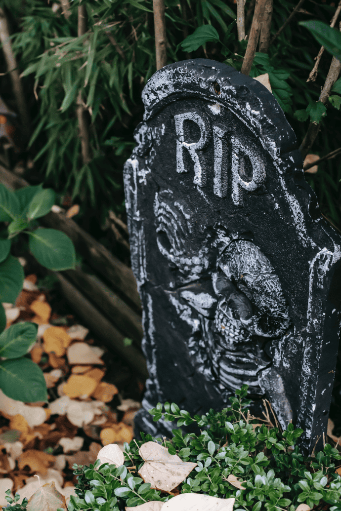 Faux Halloween gravestone with RIP, skeleton