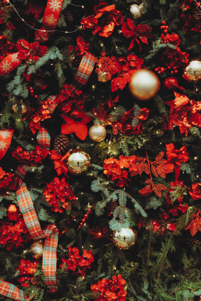 traditional Christmas tree with red florals, plaid ribbon