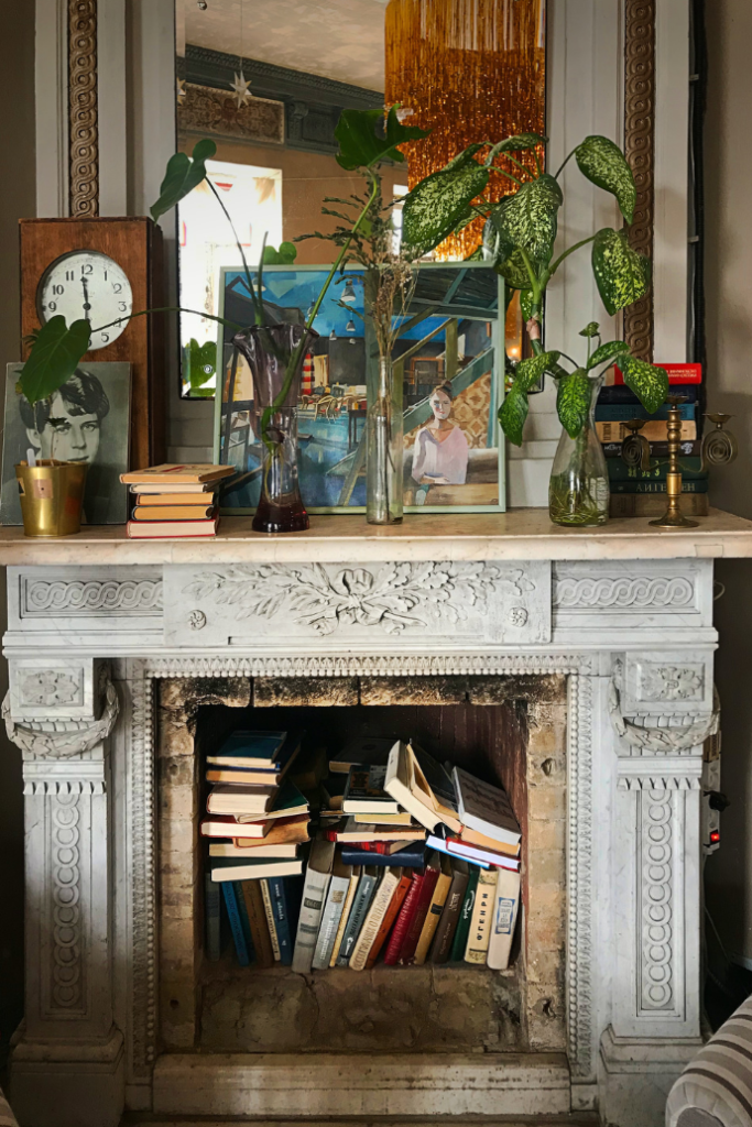 books in an empty fireplace