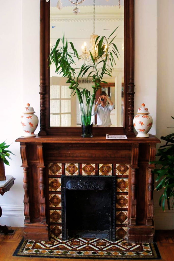 antique wood large mirror on a fireplace mantel