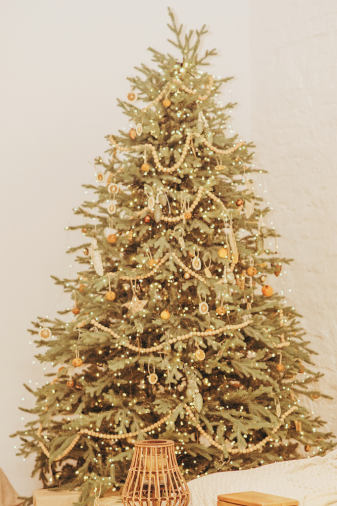 rustic, boho Christmas tree with oranges, wood bead garland