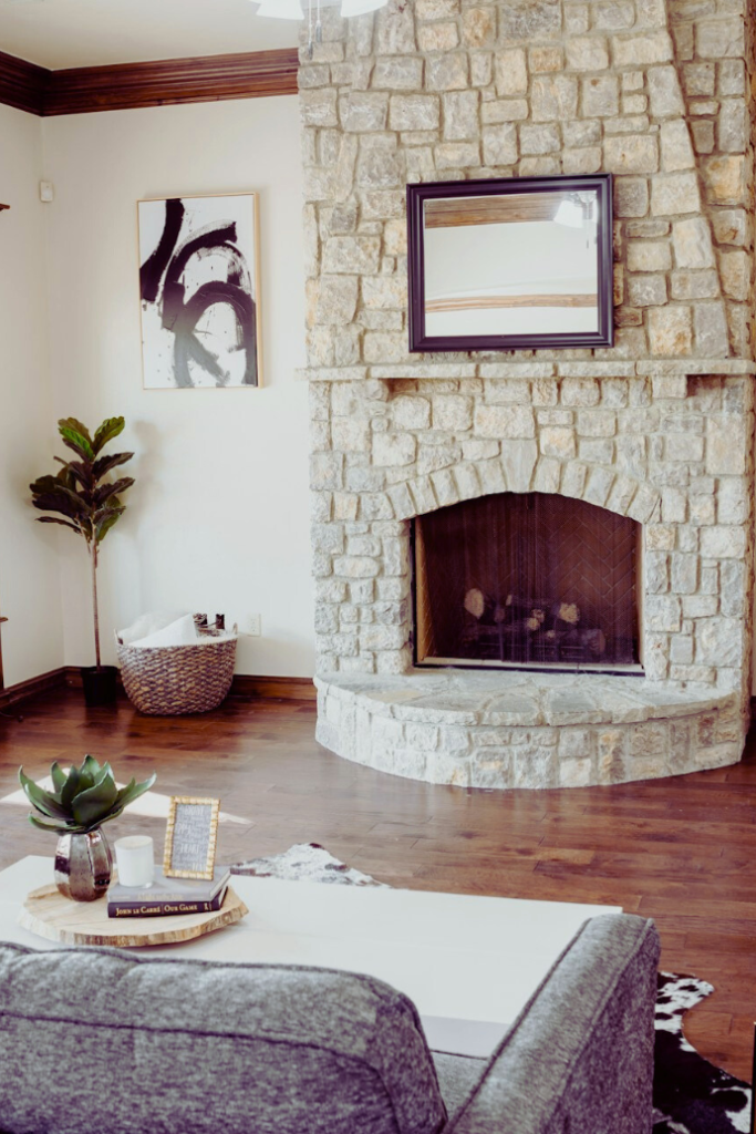 brick fireplace in living room with mirror