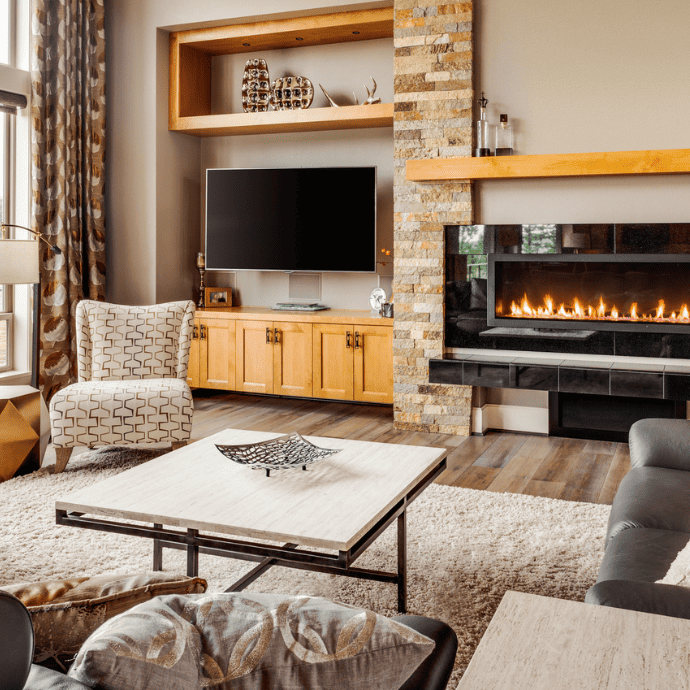 fireplace in a living room with built ins, tv to the side of the fireplace