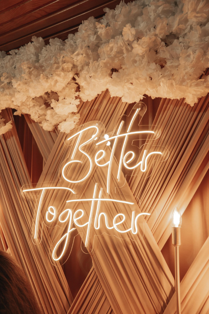 better together wedding neon sign with curtain, floral backdrop