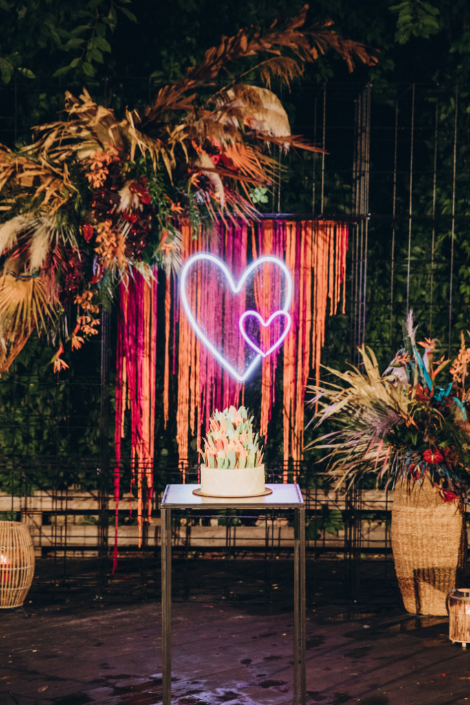 heart wedding neon sign with wedding cake, boho flowers