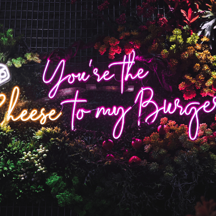 wedding neon sign saying you're the cheese to my burger