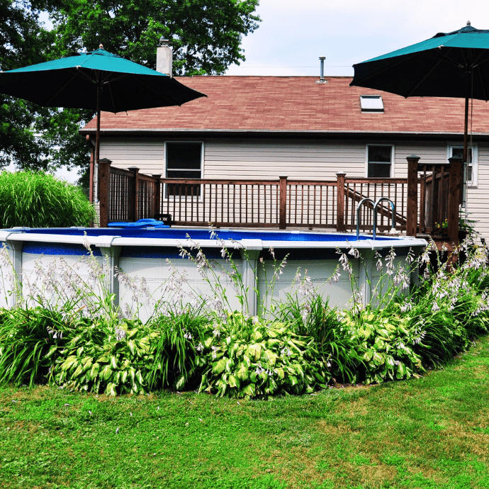 above ground pool with deck, plants, umbrella