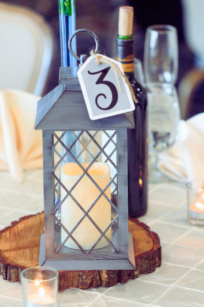 lantern with flameless candle, table number, wood charger for wedding centerpiece