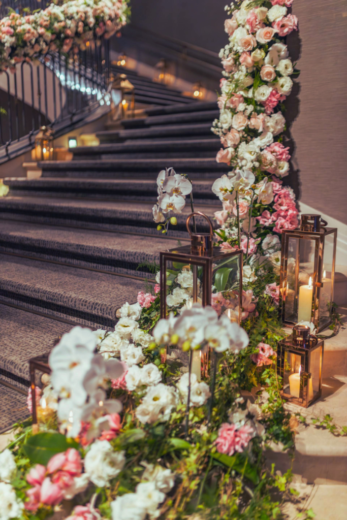 candles, lanterns, flowers down steps at wedding reception