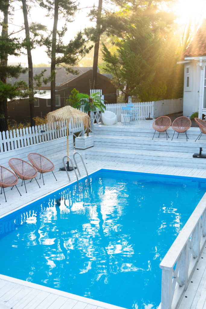 inground pool with wicker chairs, multi level