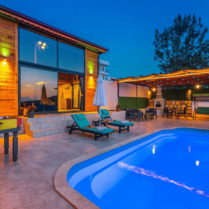 outdoor patio area with pool lights at night