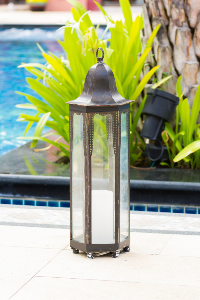 lantern by pool with landscape up lighting
