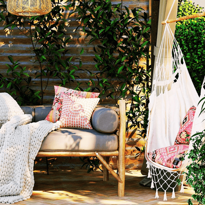 when to decorate for summer with backyard patio furniture, hanging chair, colorful pillows, boho decor