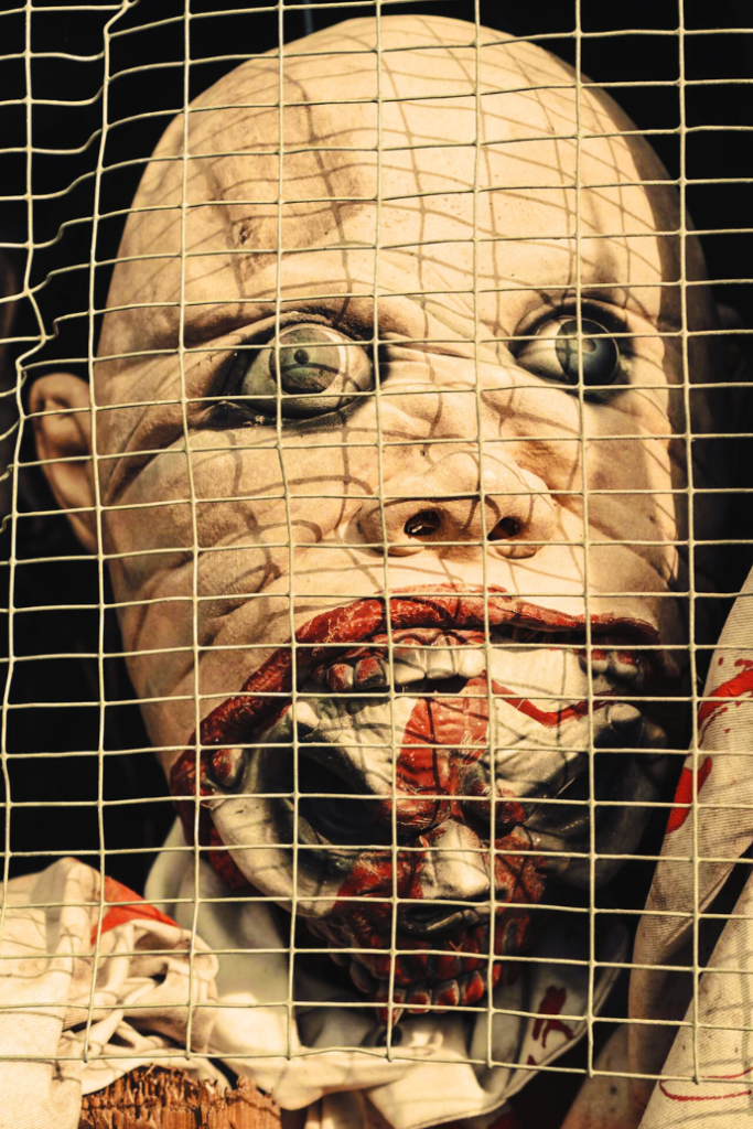 zombie head behind wire cage