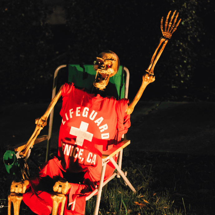 halloween skeleton with lifeguard outfit waving