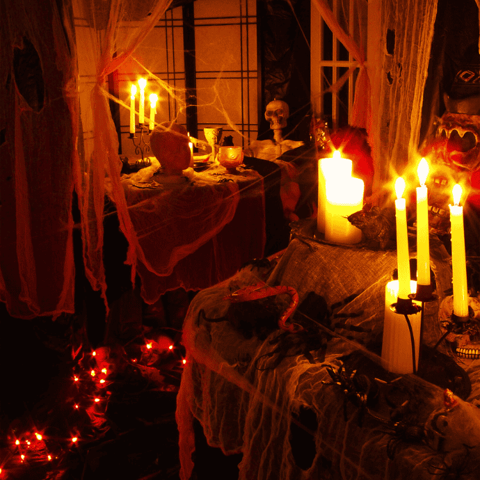 scary halloween decorations with candles, skeleton, cobwebs