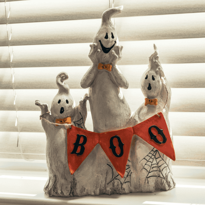 cute halloween ghosts figurine on window ledge