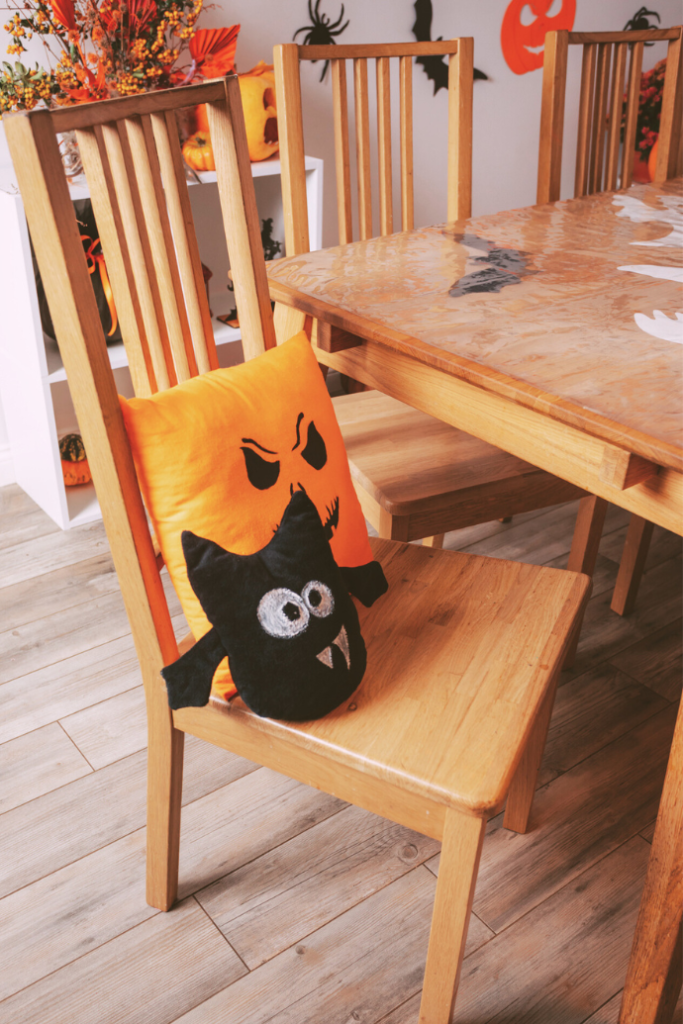 cute halloween pillows on dining room table chair