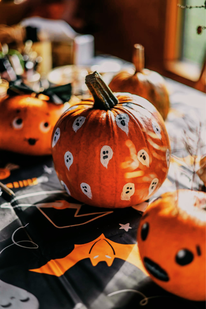 cut painted halloween pumpkin on table with table runner