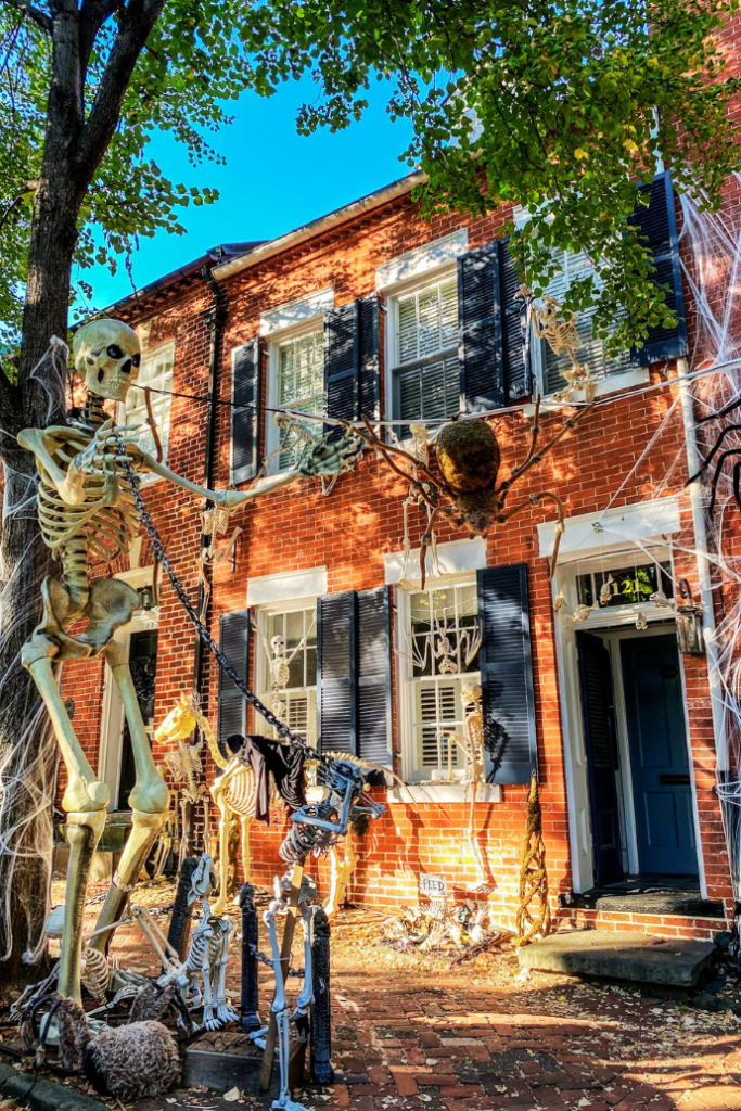 halloween front porch with extra tall decorations, skeleton, spider