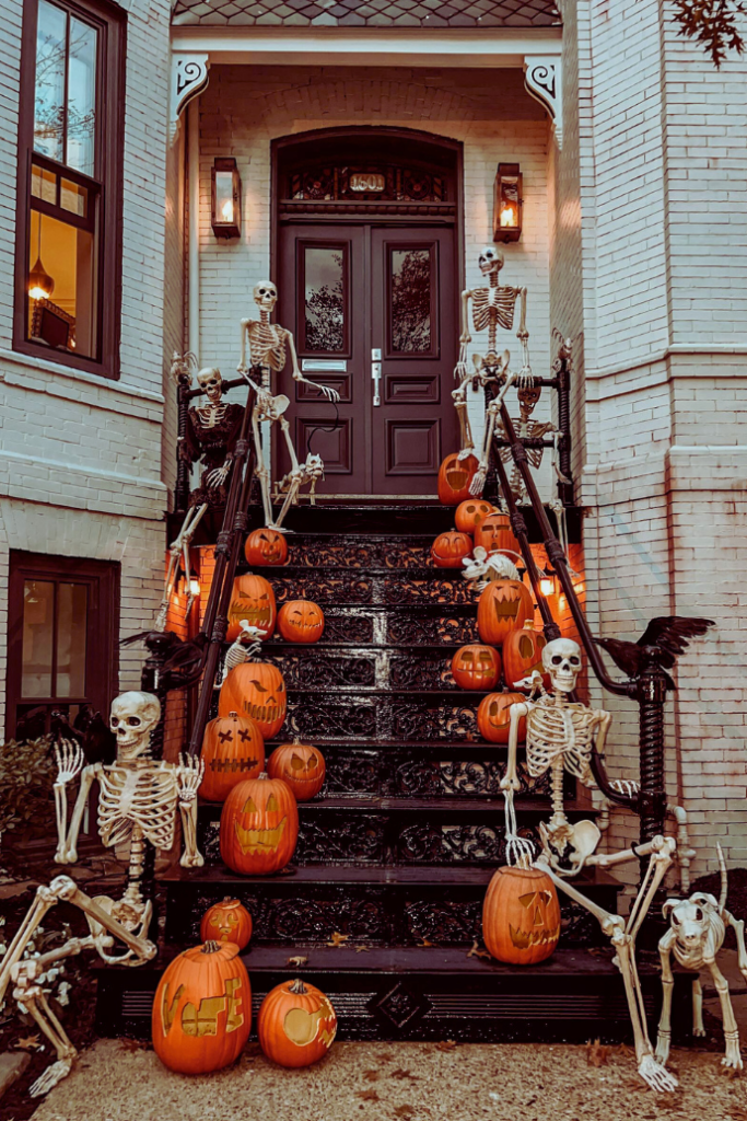 halloween front steps on brownstone with jack-o-lanterns, skeletons, crows, dog skeleton