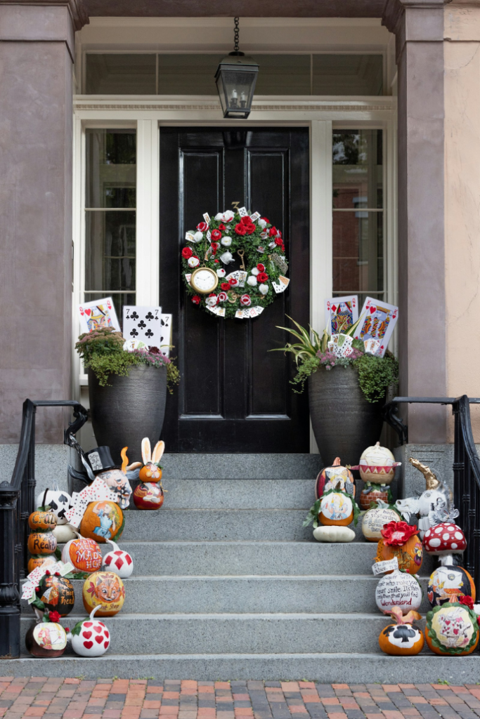 halloween front steps, door with painted pumpkins, cards, wreath