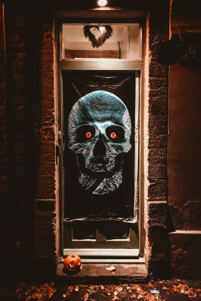 halloween front door with skull, jack-o-lanterns