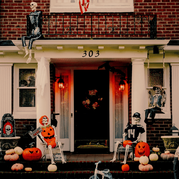 halloween front porch with skeletons, jack-o-lanterns, orange lights