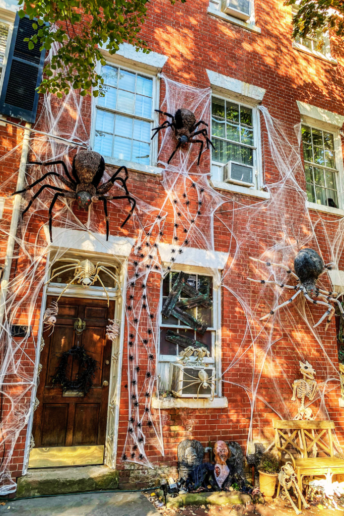 halloween front door with spiders, cobwebs, monsters, skeletons