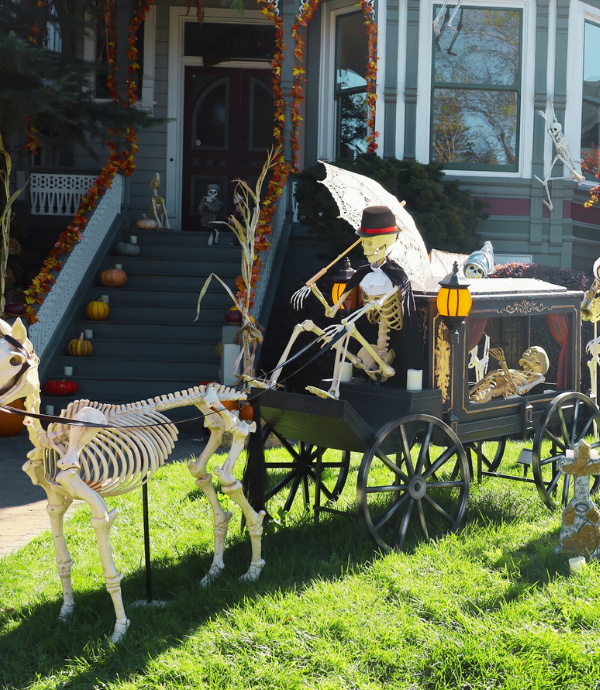 skeleton driving a hearse in halloween front yard display