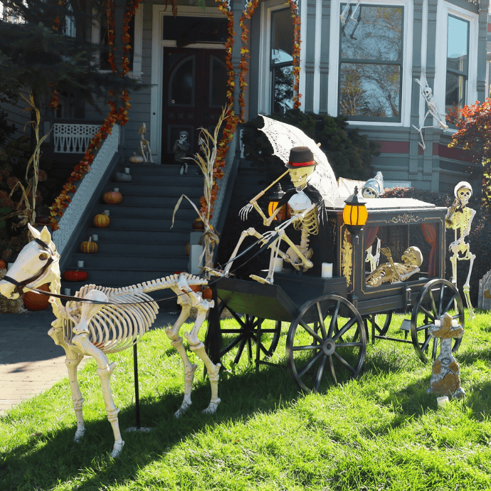 skeleton driving a hearse in halloween front yard display