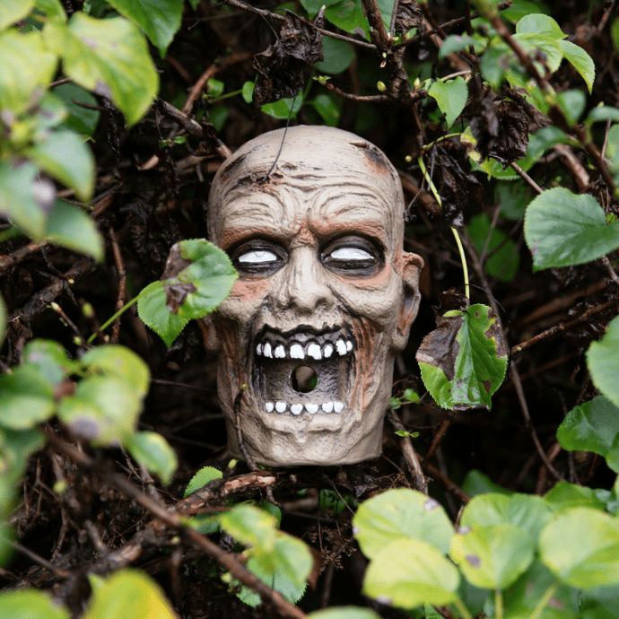 scary face mask in garden for halloween decor