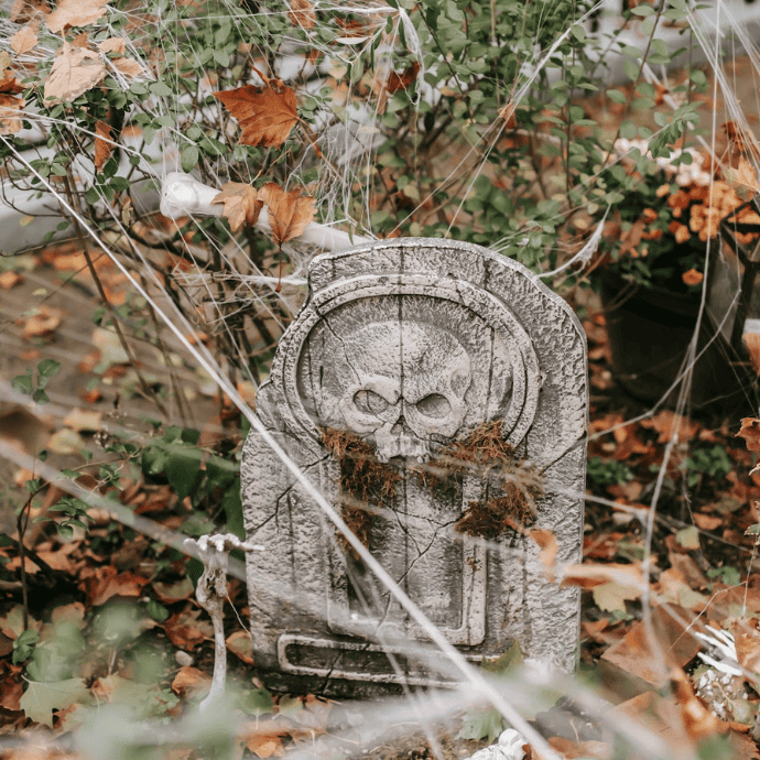 halloween tombstone with cobwebs in garden