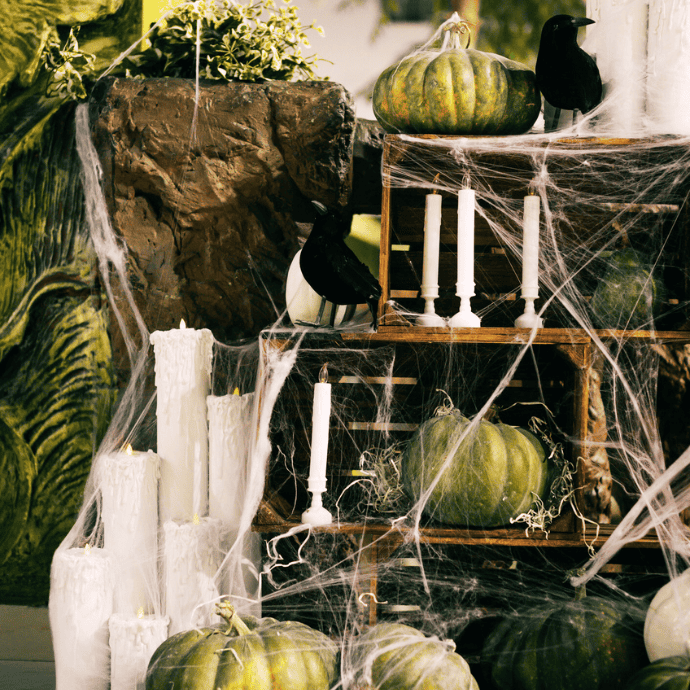 halloween pool noodle candles with shelves, pumpkins, cobwebs, ravens