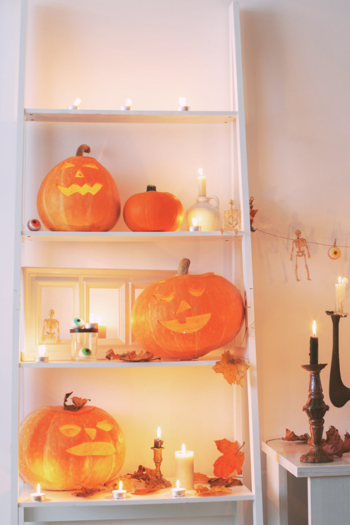 shelves with jack o lanterns, halloween candles, skeletons