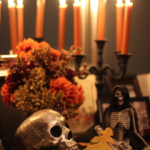 halloween candle display with taper candles, skull, flowers