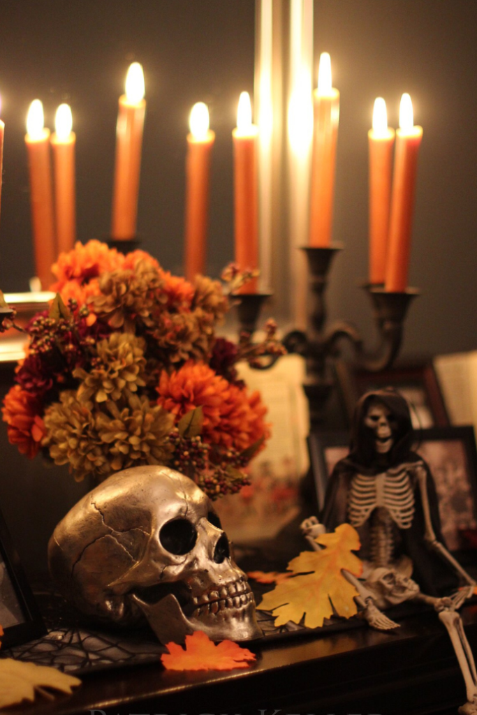 halloween candle display with taper candles, skull, flowers