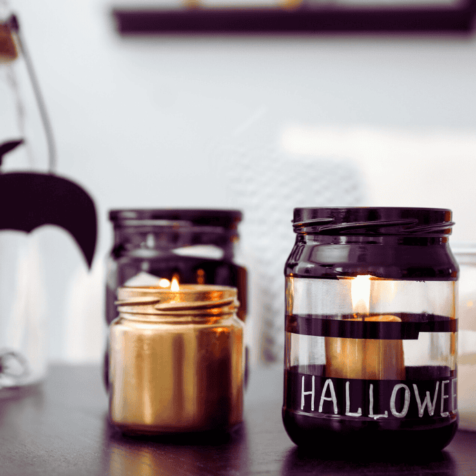 empty jars decorated for halloween candles