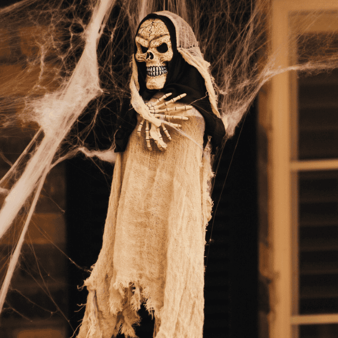 spooky halloween ghost prop hanging on front porch