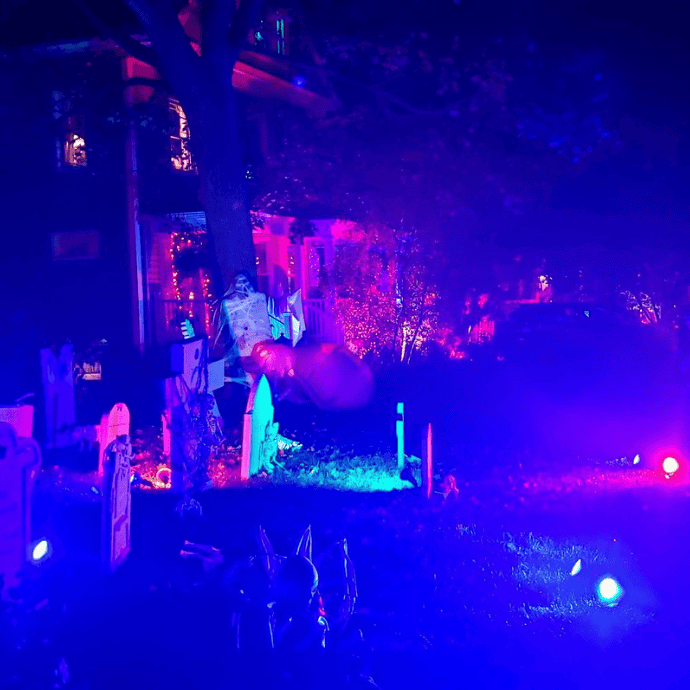 halloween strobe lights on gravestones in front yard cemetery scene