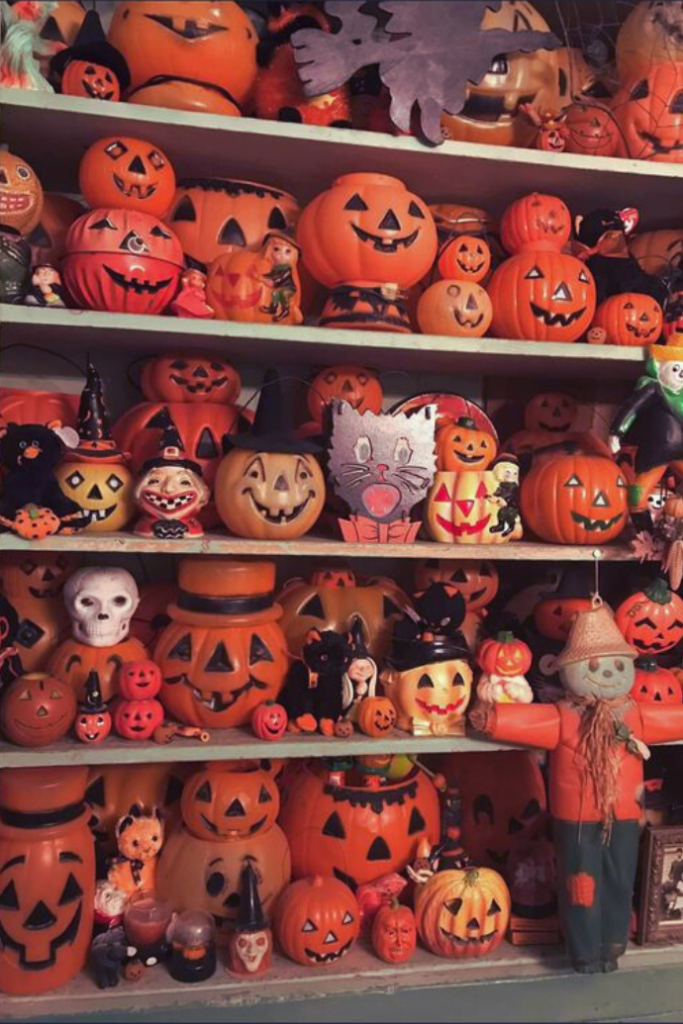 shelves with vintage halloween pumpkins, jack-o-lanterns, black cats