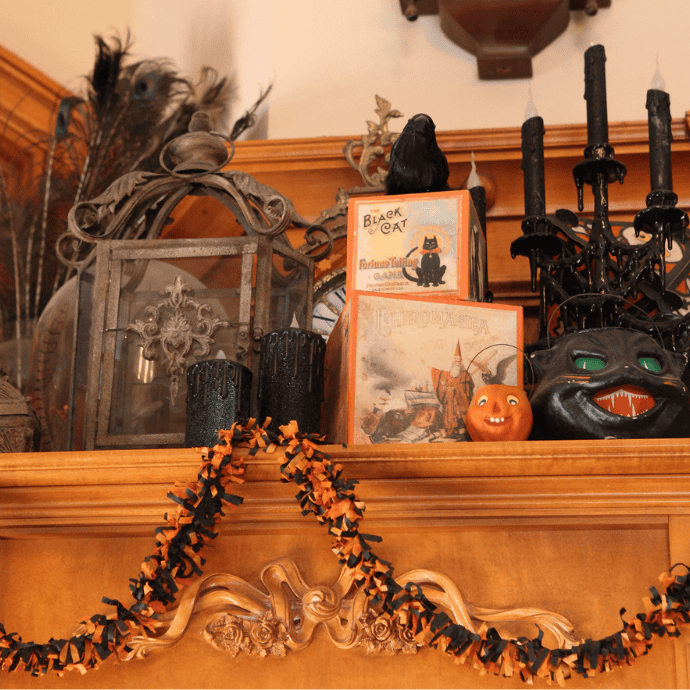 vintage halloween sideboard decorations with black cat, raven, garland, candles