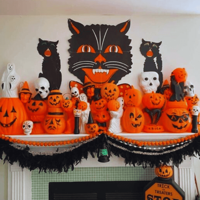 black cats, jack-o-lanterns on vintage halloween mantel