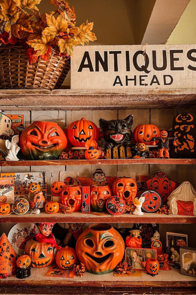 antique halloween decorations on display shelves for fall