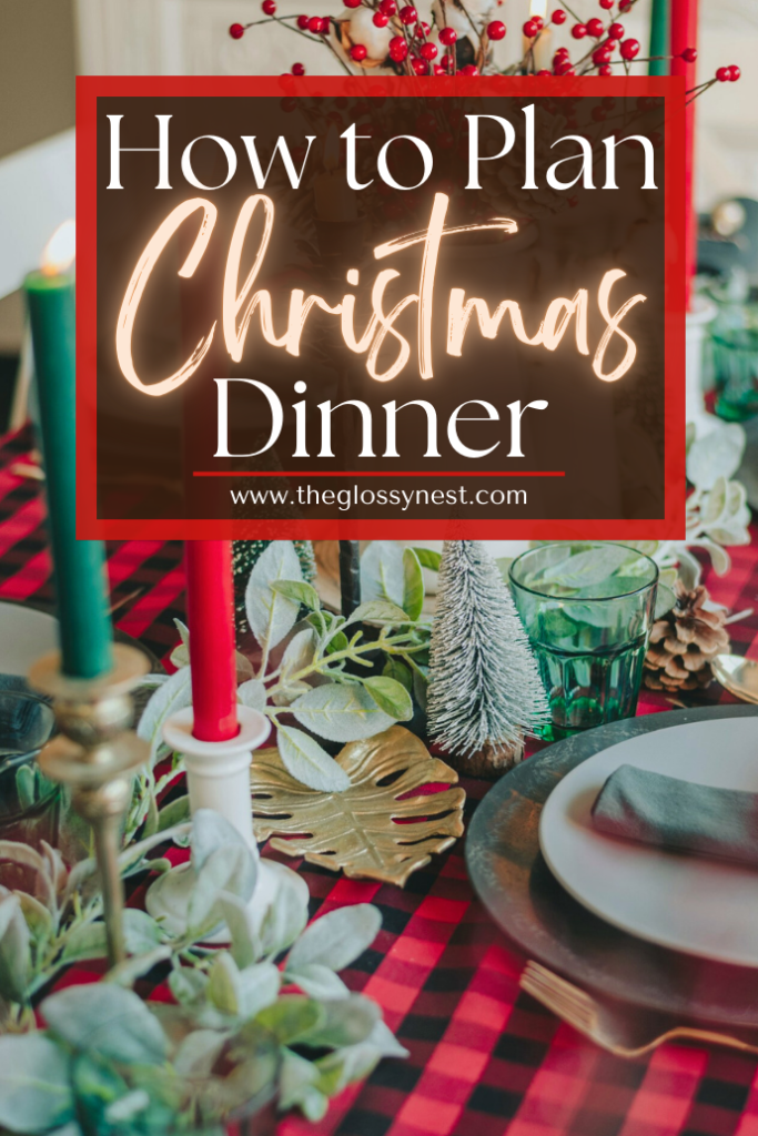 A festive table setting with a red and black plaid tablecloth, candles, pinecones, and greenery. A sign reads "How to Plan Christmas Dinner" at theglossynest.com.