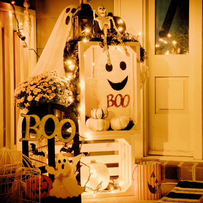 farmhouse halloween front porch decorations with ghosts, boo sign, skeletons, mums