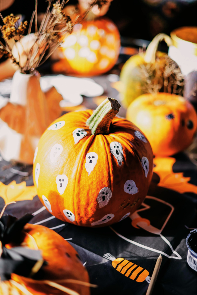 halloween decor ideas with painted pumpkins on table